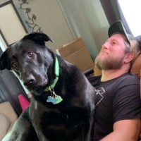 Nevin Kadlec with his black dog Roscoe.
